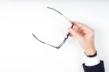 businessman hands holding black eyeglasses on white background. Isolate white.