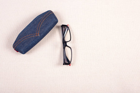 eyeglass and boxed on fabric background.の写真素材