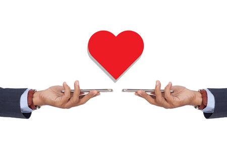 Hand holding smartphone with heart closed envelope.の写真素材