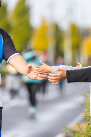 The hand of the roadside to support the runnerの写真素材
