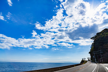 The road by the sea and the refreshing skyの写真素材