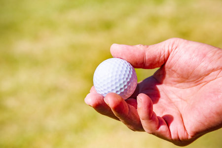 Hand with golf ballの写真素材