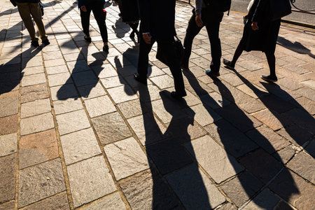 Walking people and long shadows