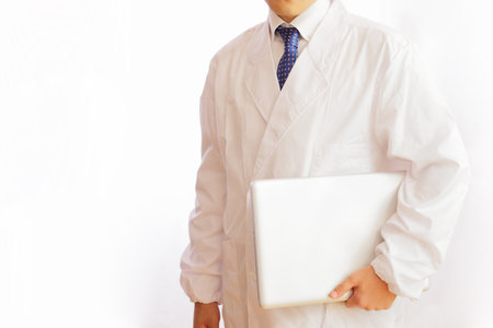 A man in white and a computerの写真素材