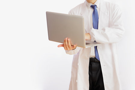 A man in white and a computerの写真素材