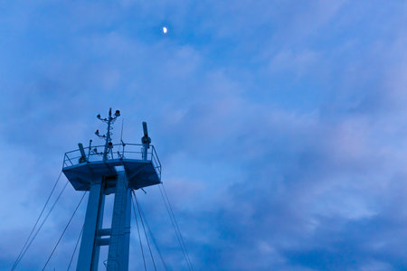 The blue sky and the moon seen from the top of the ship