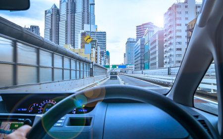 View of the highway and the city from the driver's seatの写真素材