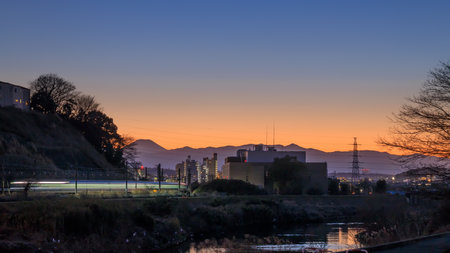 The city and railway at sunset outside Yokohama Mt. Fuji and the mountain range seen in the distanceの写真素材