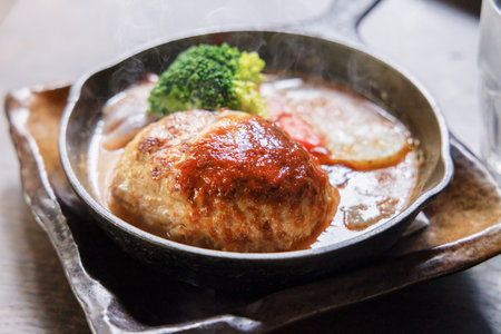 Delicious-looking hamburger steak on a frying panの写真素材