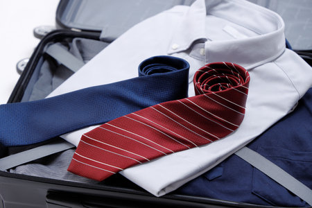 Business trip preparation of businessmen. Carry case and shirt