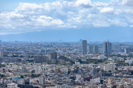 Blue sky, clouds and buildings in Tokyoの写真素材