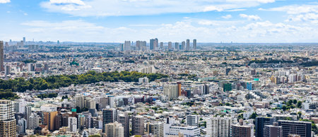 Blue sky, clouds and buildings in Tokyoの写真素材