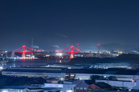 The cityscape of the Kitakyushu factory area at night seen from a hillの写真素材