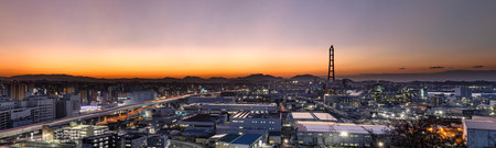 The townscape of the Kitakyushu factory area at dusk seen from a hillの写真素材