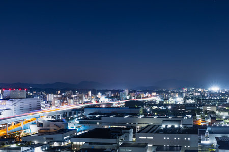 The cityscape of the Kitakyushu factory area at night seen from a hillの写真素材