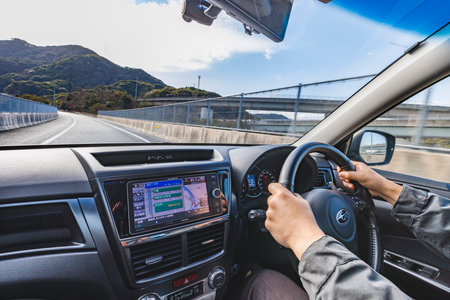 A person driving a car while looking at the beautiful scenery outsideの写真素材