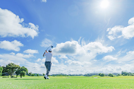 People playing at a beautiful green golf courseの写真素材