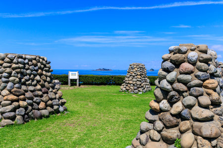 Stone wall with blue sky and sea in the background, Okinawa, Japanの写真素材