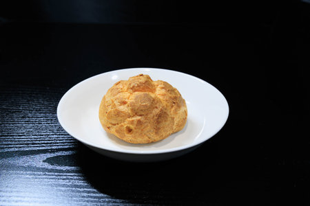 Fresh cream puffs on black background
