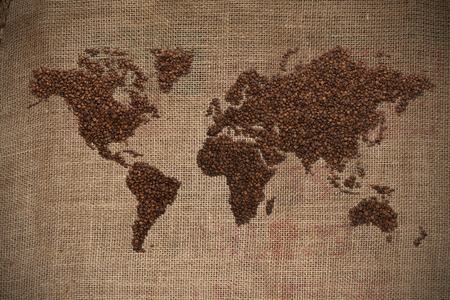 Wold map made of coffee beans on textured backgroundの写真素材