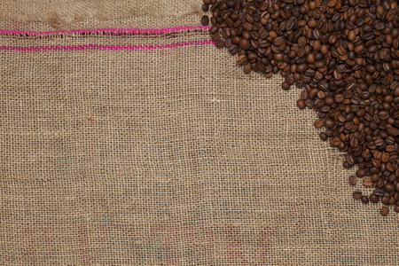 Coffee beans on a jute backgroundの写真素材