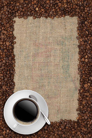 Coffee beans and Coffee cup on a jute backgroundの写真素材