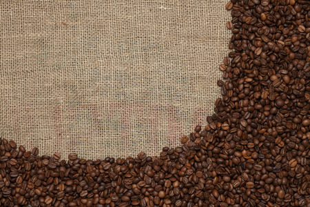 Coffee beans on a jute backgroundの写真素材