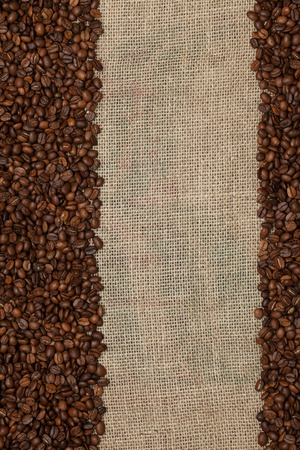 Coffee beansCoffee beans on a jute backgroundの写真素材