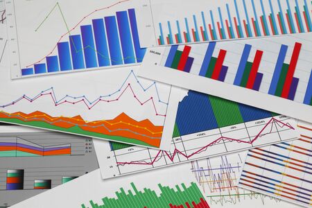 Financial paper charts and graphs on the table