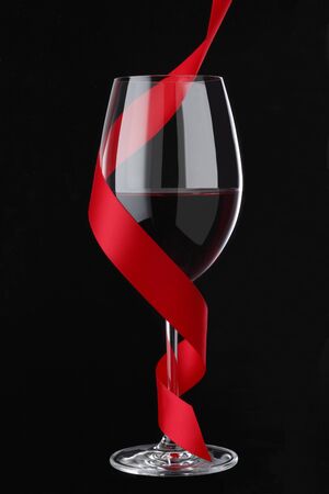 Red Wine with Red Ribbon on blackclipping pathの写真素材