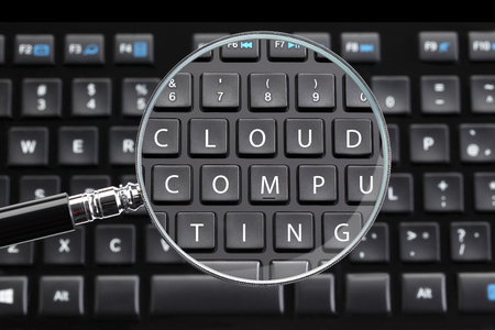 CLOUD COMPUTING written on keyboard with magnifying glassの写真素材