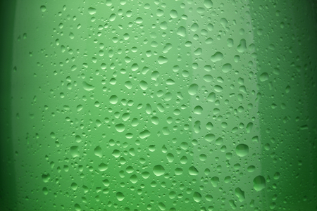 A large green glass bottle filled with carbonated waterの写真素材
