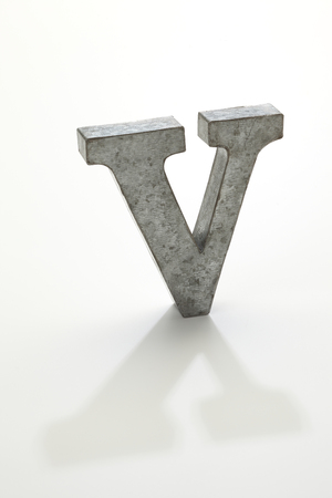 iron letter V isolated on whiteの写真素材
