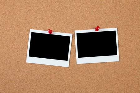 Blank instant photo on a cork boardの写真素材