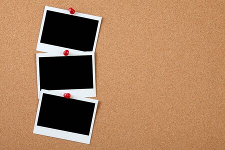 Blank instant photo on a cork board