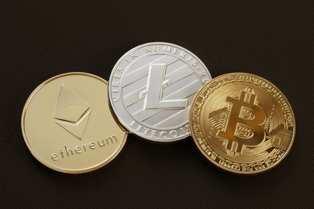 Studio shot of Gold etereum litecoins, Bitcoin on black background. Digital virtual currencyの写真素材