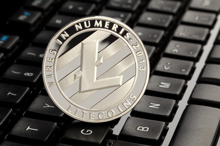 Litecoins (virtual coins) on a top of a keyboard