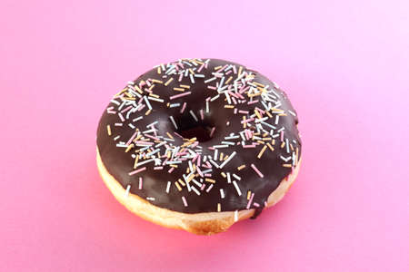 Sweet chocolate donut on pink background. Dessert foodの写真素材