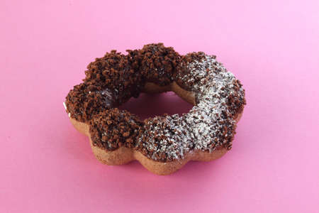 Sweet chocolate donut on pink background. Dessert foodの写真素材