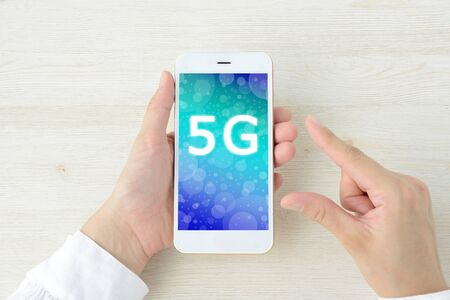The hand of the person who uses the smartphone of 5Gの写真素材
