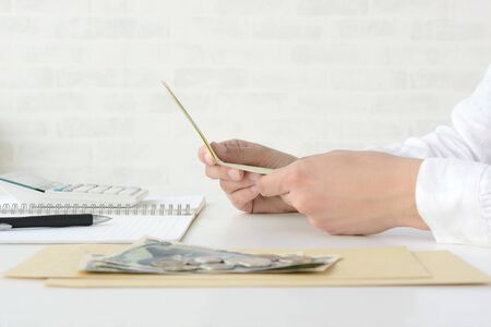 Hand of the person who checks the passbook