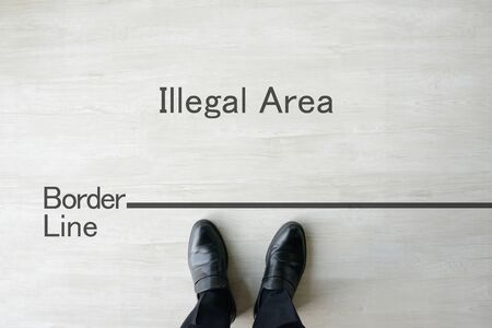 a businessman standing on the borderlineの写真素材