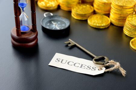 Gold coins and the key to successの写真素材