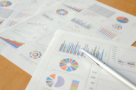 Business charts and ballpoint pensの写真素材