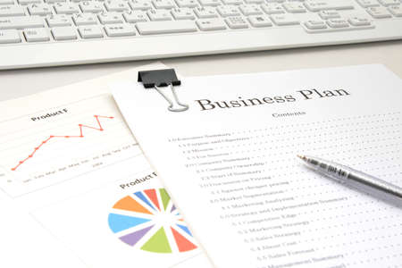 Business plan placed at the deskの写真素材