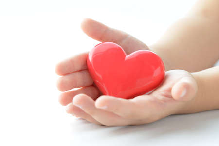 Children's hands with heart objectsの写真素材