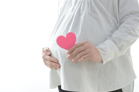 Maternity image of a pregnant woman with a heart object on her stomach