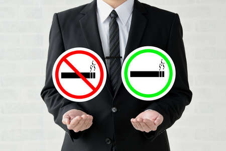 Businessman with non-smoking and smoking marksの写真素材