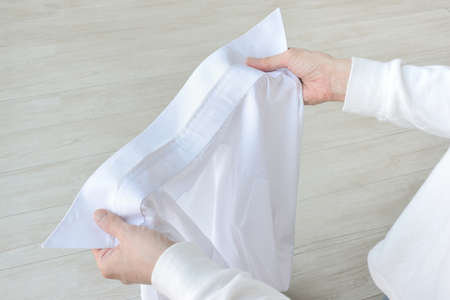 The person who confirms the collar stain of the shirtの写真素材