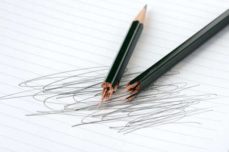 a broken pencil and a messy notebookの写真素材